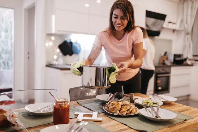 Women setting dinner table to break their fast